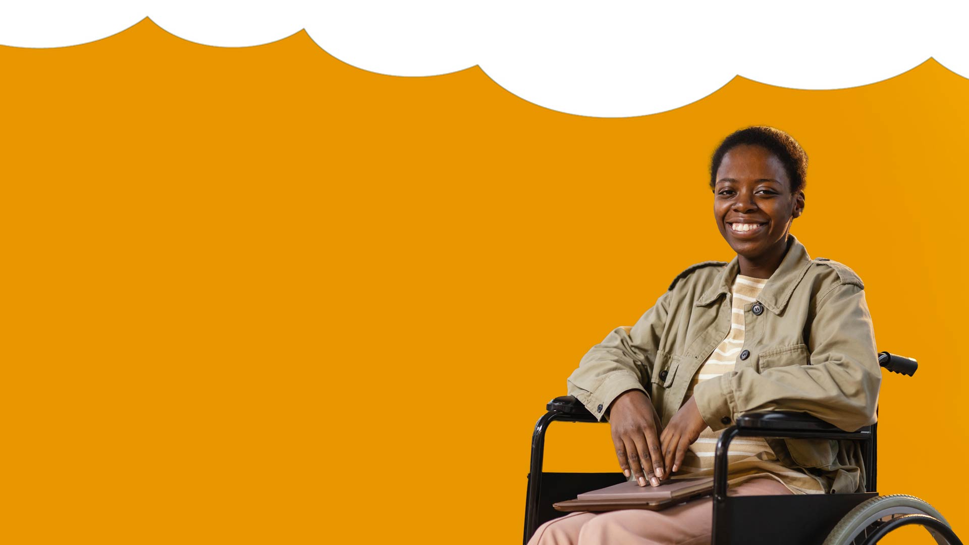 Black woman in wheelchair, smiling.